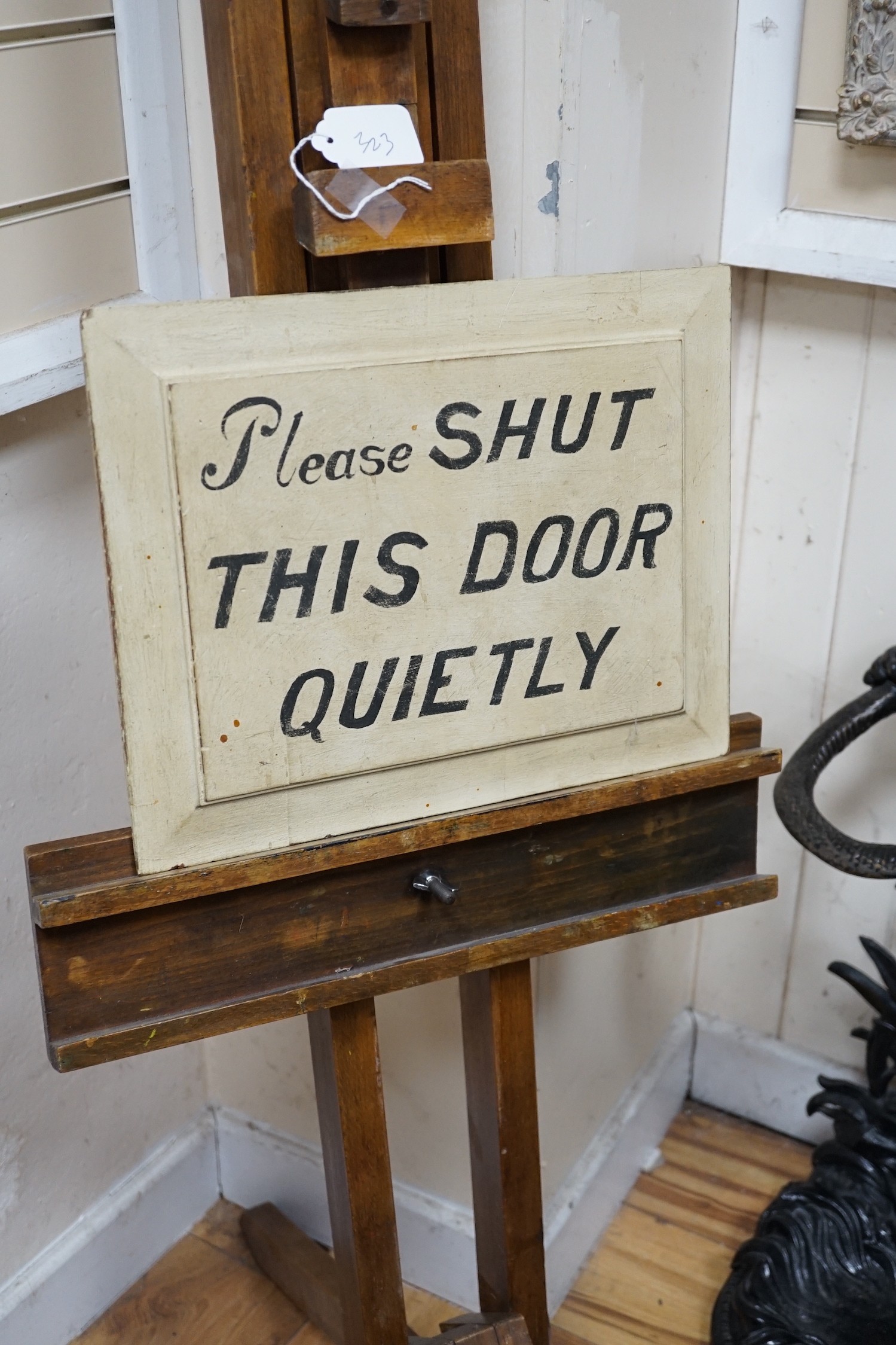 A beech artist's easel, height 170cm, with a door shutting sign *Please note the sale commences at 9am.